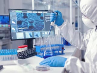 Dịch Vụ Xét Nghiệm ADN Huyết Thống Virolog coducting experiment in the course of coronavirus pandemic